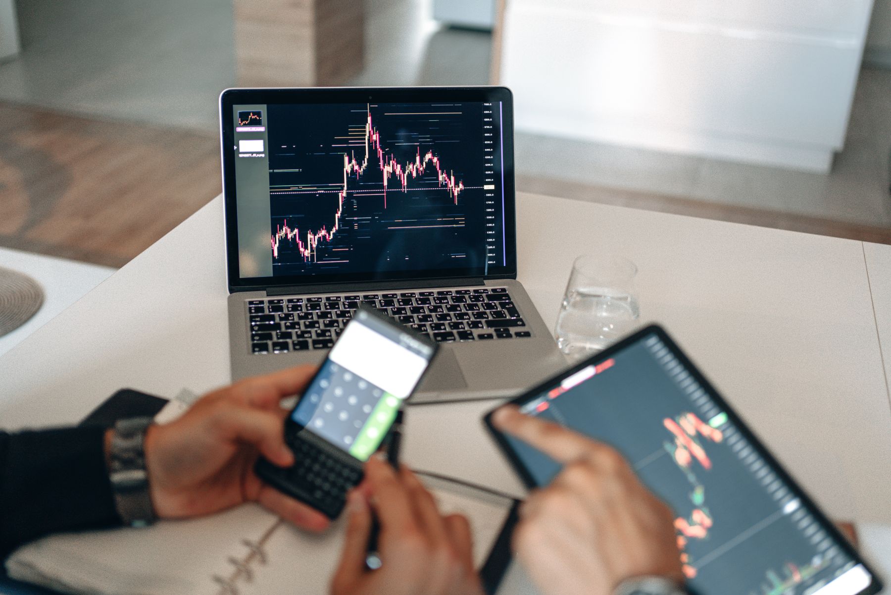 Campaign performance data reviewed across a laptop, phone, and tablet